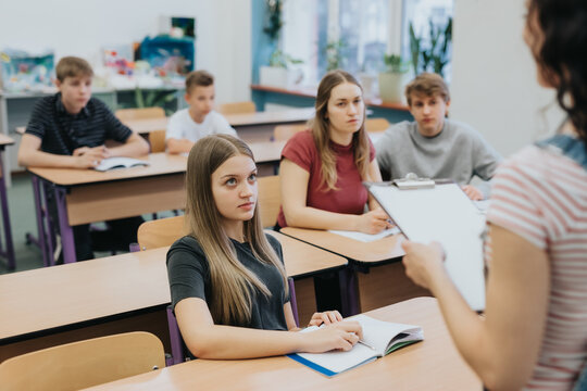 Group Of Teenagers Sitting At School Desks During Math Class Lessons