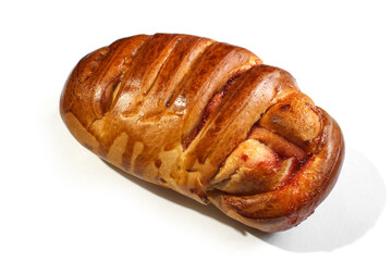 tasty baked bun with crispy golden crust and sweet berry jam on a white background