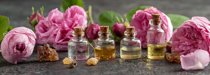 Panoramic header of essential oil bottles, frankincense and rose de mai