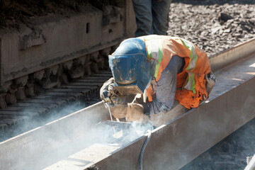 Construction worker welding on a steel I beam