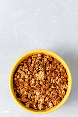 Homemade oatmeal granola bowl on ligth grey background.