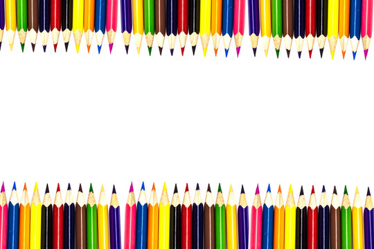 Multi-colored, bright sharpened pencils in different positions on a white background. Pencil sharpener. Pencil shavings.