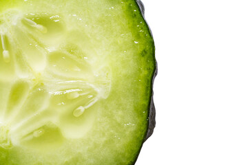 green cucumber in a close-up section on most of the image, copy the space. blurred to the edge of the frame