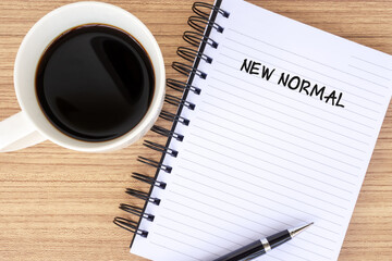 New normal text on note pad with coffee