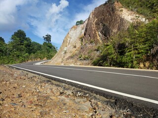 the view on the hill with blue sky and asphalt road