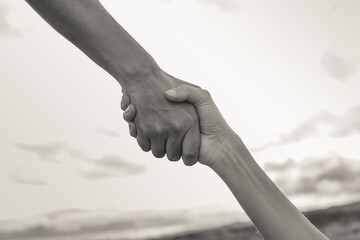 Close up of hands holding each other. Giving a helping hand