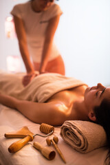 Obraz na płótnie Canvas Young woman receiving massage in spa salon.