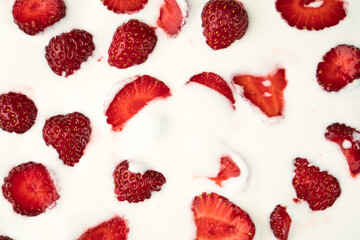 Pieces of strawberries on the surface of a dairy product