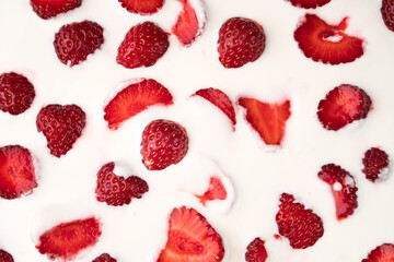 Pieces of strawberries on the surface of a dairy product