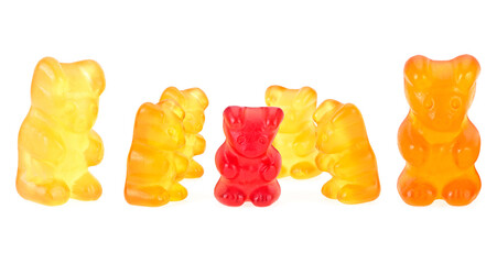 Yellow gummy bears and a single red one on a white background. Children's multivitamin.
