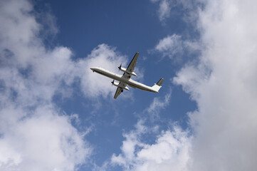 Domestic propeller airplane flying in the blue sky