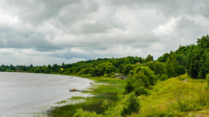 Fototapeta premium Green nature, plants, cloudy sky, river, outdoor, rain.