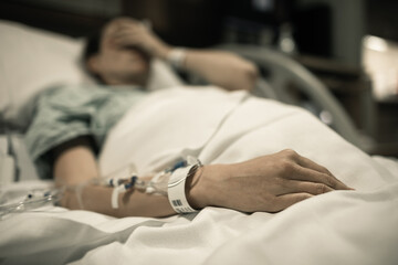 Young woman patient lying at hospital bed feeling sad