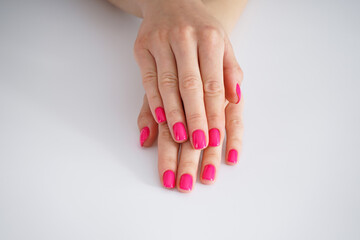 Beautiful female hands and beautiful manicure on a white background. Beauty and skin care concept.