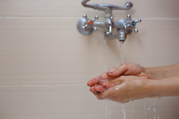 Fototapeta premium Person washing hands with antibacterial solution.