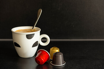 Fresh cup of coffee with capsules.