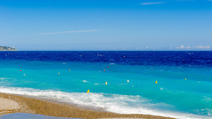 Fototapeta na wymiar It's Mediterranea sea coast in Nice, Promenade des Anglais, France. Nice is the capital of the Alpes Maritimes departement