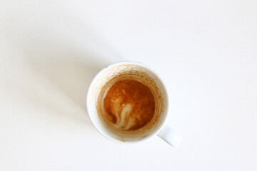 dirty empty coffee cup top view. top view empty and dirty cup of coffee on a white background