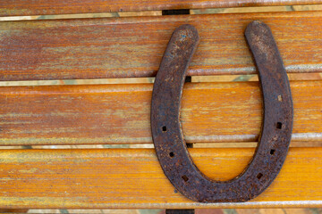 old and rusty horseshoe on wood