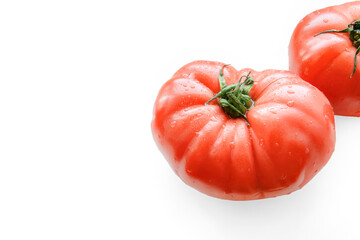 Red juicy tomatoes on a white isolated background