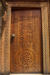 Cross on wooden door of temple, manual work