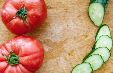 tomatoes and cucumber on wooden table