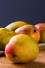 Mango. Some mangos together on wooden background