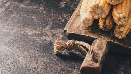 Ripe corn on dark background.