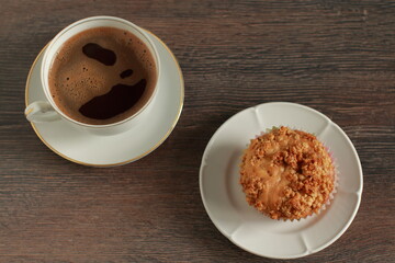 Time for a break with coffee and muffin on a desk