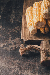 Ripe corn on dark background.