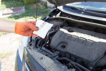 Checking the oil level in the car engine box