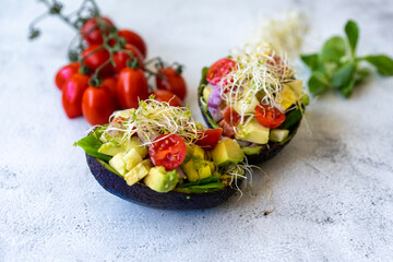 Avocado salad with watercress, cherry tomatoes, and alfalfa sprouts.