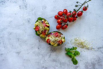 Avocado salad with watercress, cherry tomatoes, and alfalfa sprouts.