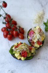 Avocado salad with watercress, cherry tomatoes, and alfalfa sprouts.