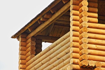 Fototapeta premium New wooden home, russian style country house with balcony fragment close up on a sunny summer day