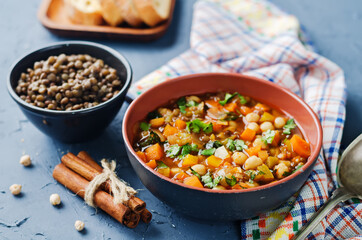 Moroccan spicy green lentils chickpea soup in a dark bowl