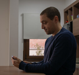 young man with his cell phone at home