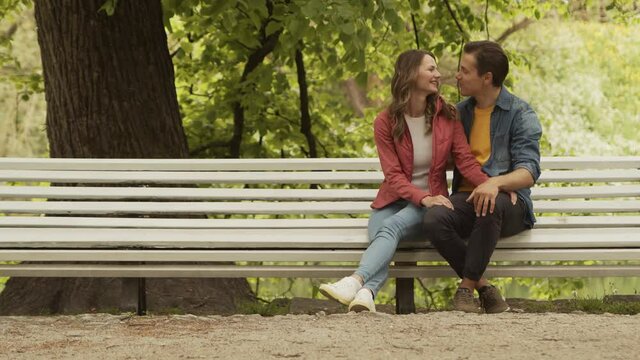 Young, happy, loving couple having date in the park. Relations, friendship and love concept.