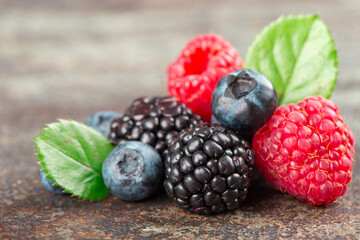 Summer Berries mix with Raspberry, Blueberry and Blackberry on dark background.