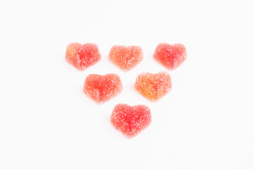 Obraz na płótnie Canvas Red marmalade hearts in sugar on a white background. Marmalade sweets. Valentine's Day. Dessert. Copy space. View from above