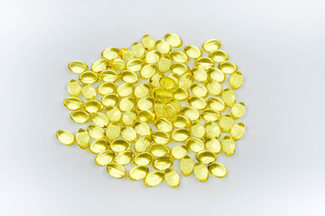 Capsules of fish oil isolated against a plain white background