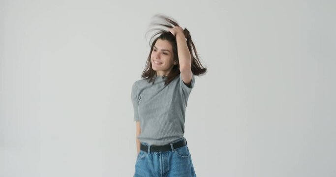 Portrait of happy woman dancing over white background