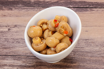 Pickled champignons in the bowl