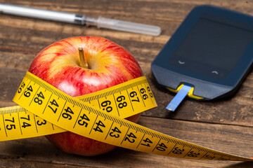 Apple with measuring tape, symbolizing overweight
