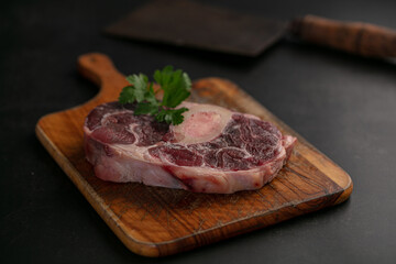 Slice of raw beef shank on a cutting board