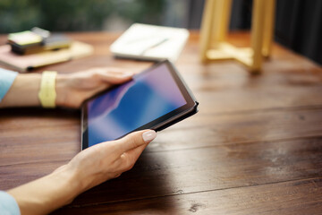 Woman pointing on digital tablet screen, chatting in social networks, meeting website, searching internet, sending sms, using text messenger or online banking. Close up photo