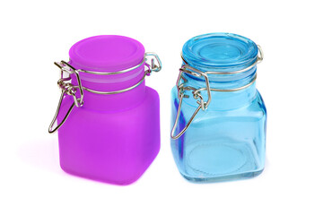 Empty glass spice jar. Purple and blue jars for spice isolated on a white background. Cooking utensil. Kitchen ware. Kitchen utensils.