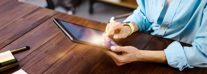 Woman pointing on digital tablet screen, chatting in social networks, meeting website, searching...