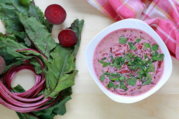 Home made beetroot soup with beets on wooden table flat lay top view	