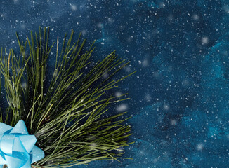 Snow background with Christmas tree branch and bow, copy space for winter holiday.